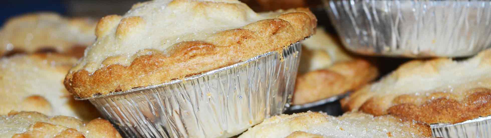 A bunch of mini pies in foil containers