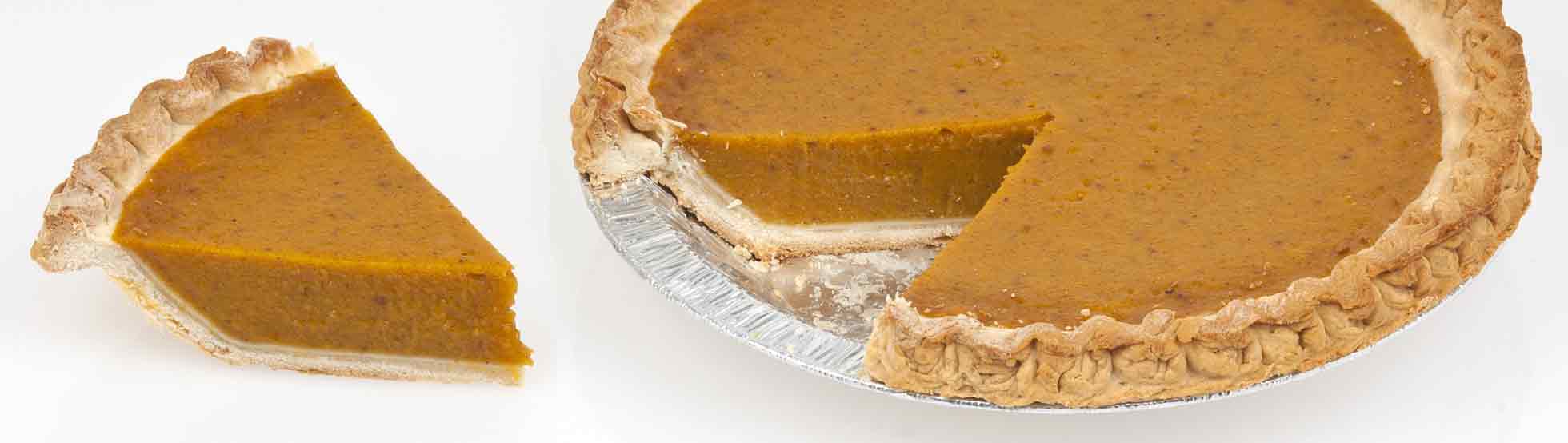 A pumpkin pie in a foil container with a slice taken out
